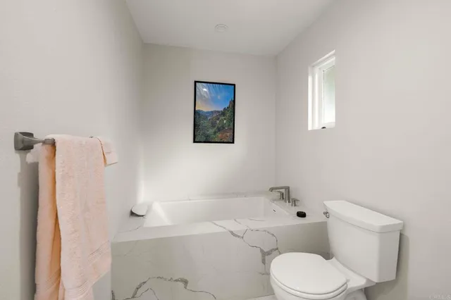 a spacious bathroom with a granite countertop sink a mirror and shower