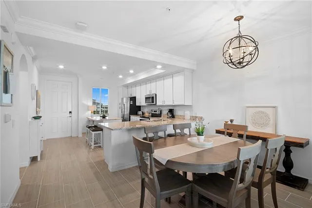a view of a dining room with furniture wooden floor and a chandelier