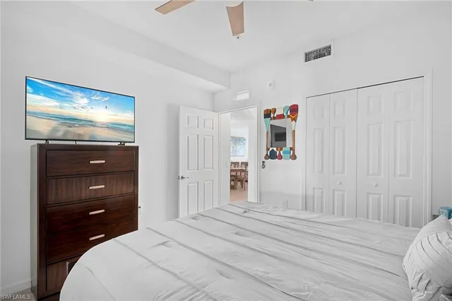 a bedroom with a bed and a mirror