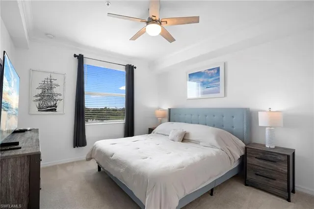 a bedroom with a large bed and a chandelier