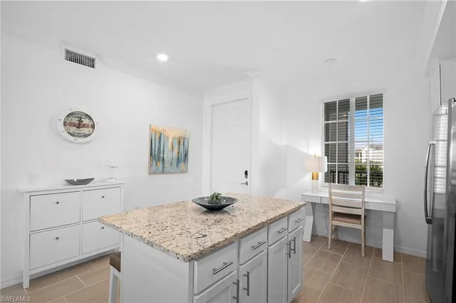 a kitchen with a sink cabinets and wooden floor