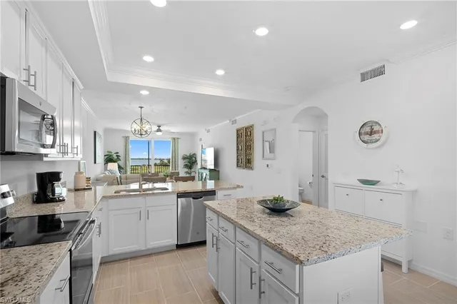 a kitchen with a sink dishwasher stove and cabinets
