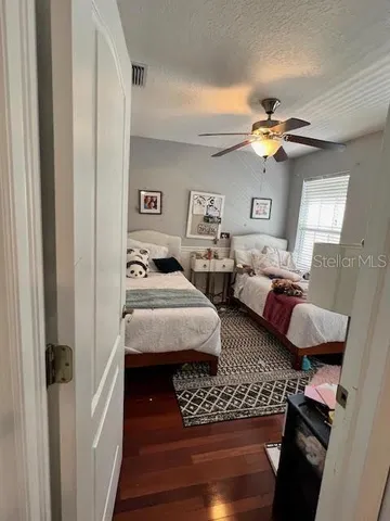 a bedroom with two beds and a chandelier