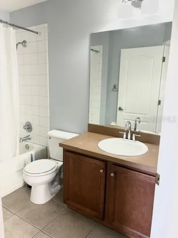 a bathroom with a sink toilet mirror and shower