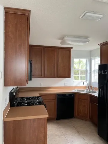 a kitchen with a sink and a stove top oven