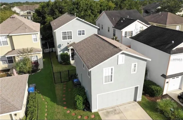 an aerial view of a house with a yard