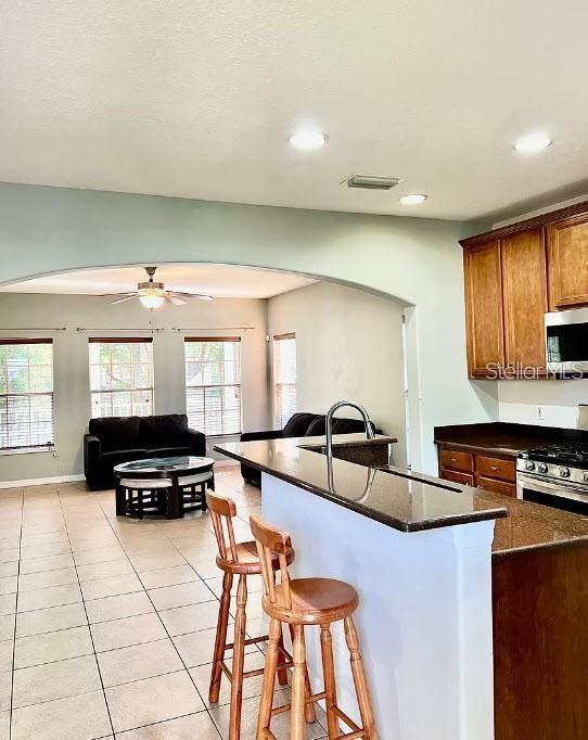 16113 Bridgecrossing Drive Lithia, FL 33547 - Photo 4 of 24 a living room with furniture a flat screen tv and a window