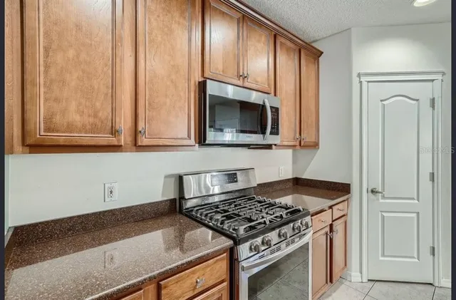 a kitchen with granite countertop cabinets and steel stainless steel appliances
