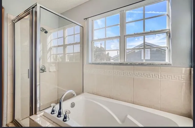a bathroom with a bathtub and a shower