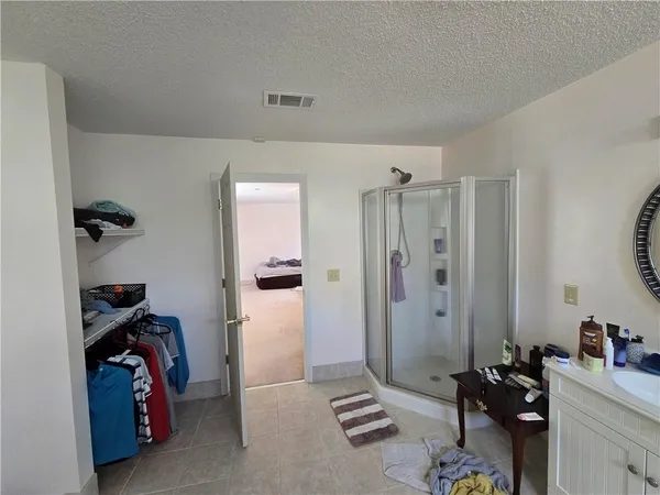 a spacious bathroom with a granite countertop sink and a mirror