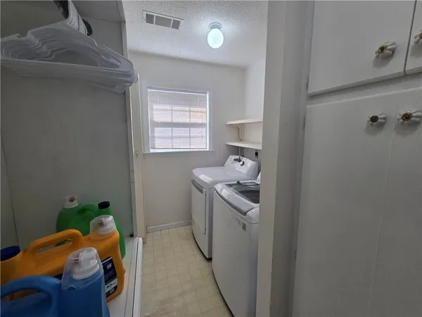 a living room with furniture and a gym equipment