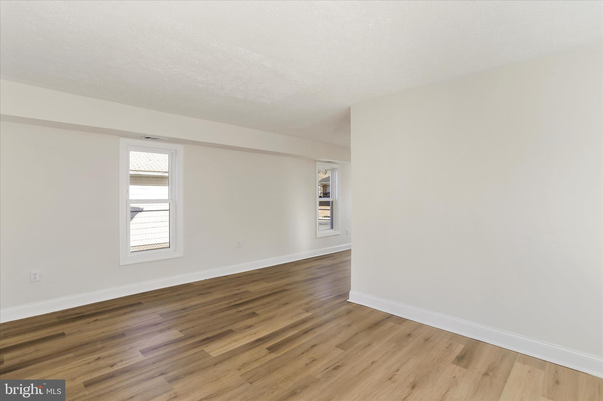 641 South Raleigh Street Martinsburg, WV 25401 - Photo 13 of 34 an empty room with wooden floor and windows