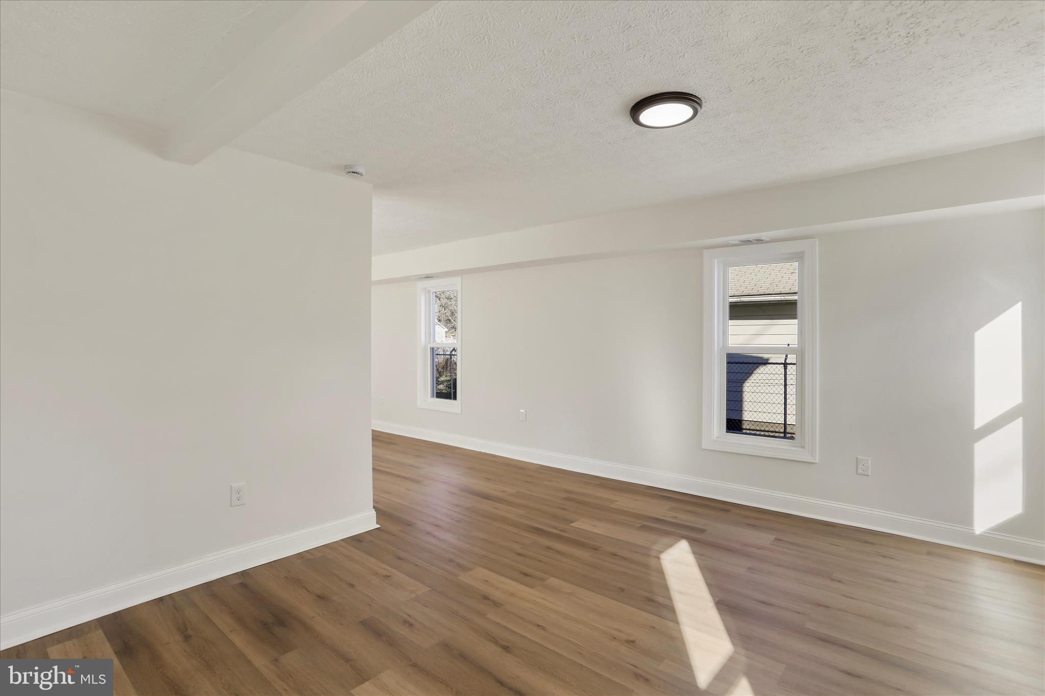 641 South Raleigh Street Martinsburg, WV 25401 - Photo 17 of 34 an empty room with wooden floor and windows