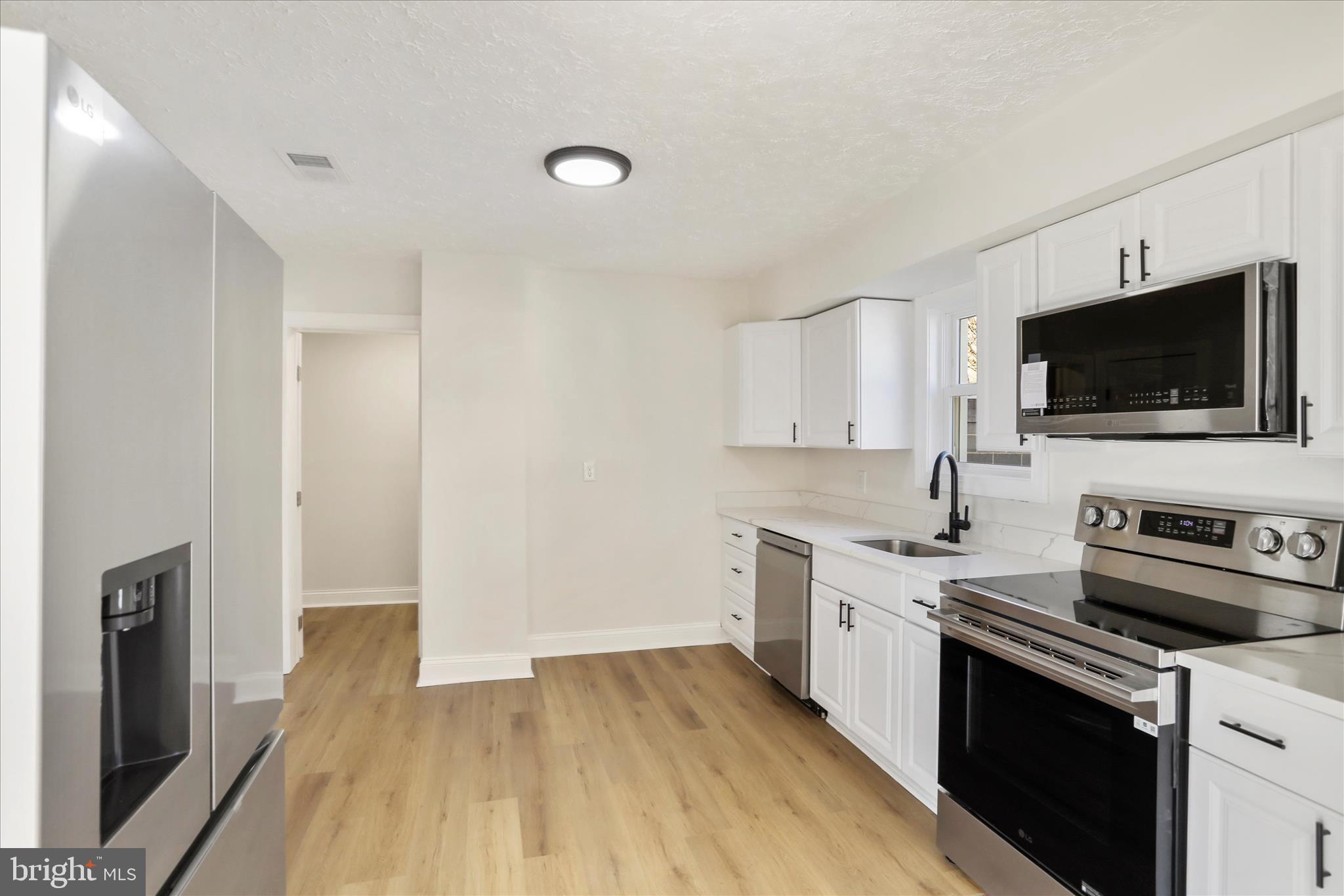 641 South Raleigh Street Martinsburg, WV 25401 - Photo 8 of 34 a kitchen with a sink stove and microwave