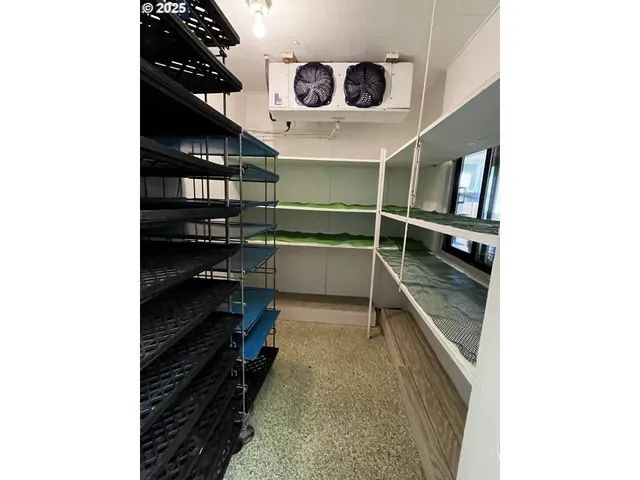 a room with water heater and utility racks