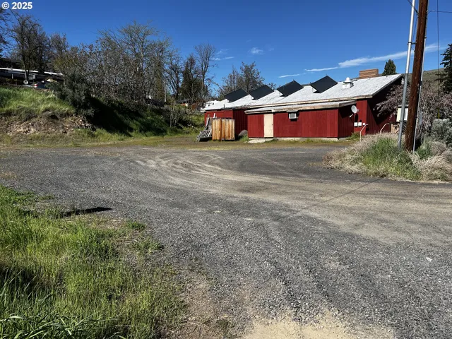a large house that has a tree in front of it