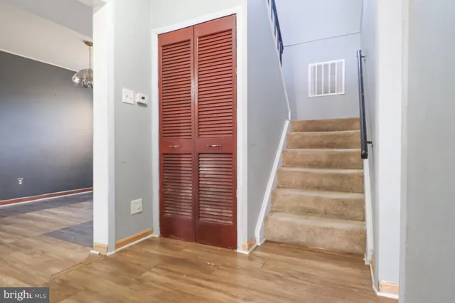 a view of a hallway with wooden floor and windows