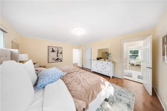 a spacious bedroom with a bed and a large mirror