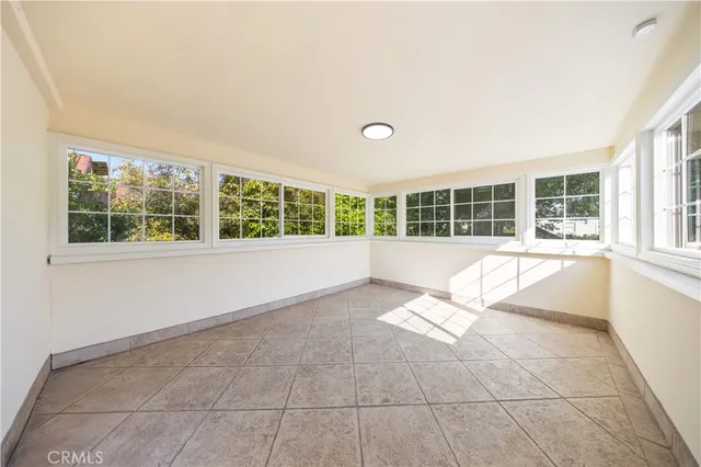 a living room with a large window and a rug