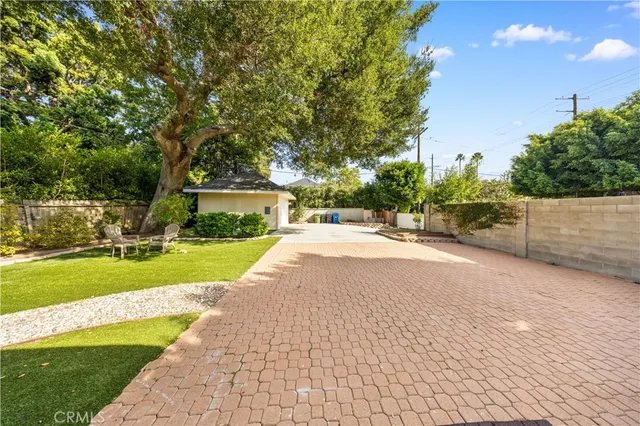 a view of yard with swimming pool and green space