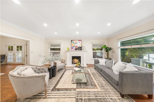 a living room with furniture large window and a fireplace