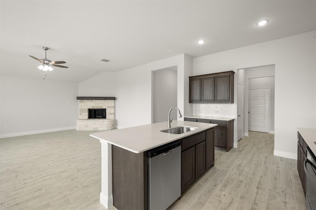 228 Shepards Street Godley, TX 76044 - Photo 6 of 27 a kitchen with sink stove and refrigerator