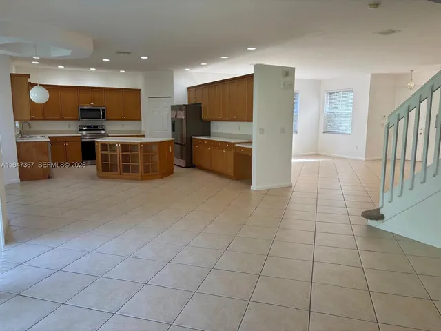 a kitchen with stainless steel appliances a sink and counter top space