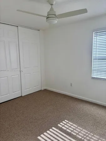 a view of an empty room with staircase