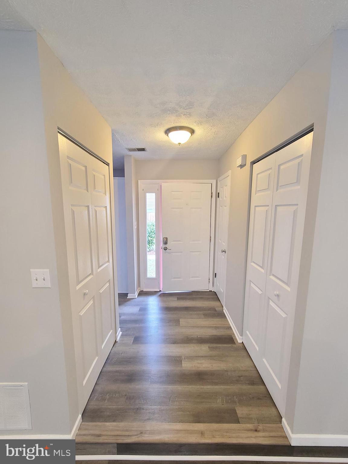 18042 Ohara Circle Olney, MD 20832 - Photo 2 of 35 a view of a hallway with wooden floor and a bathroom