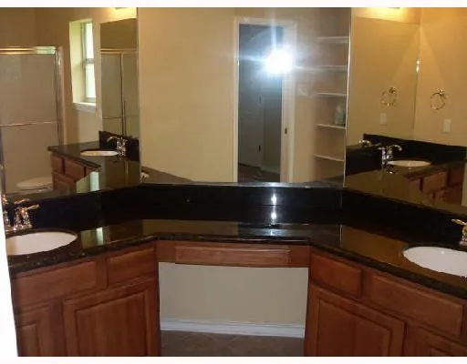 a kitchen with a sink and a mirror