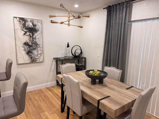 a view of a dining room with furniture and wooden floor