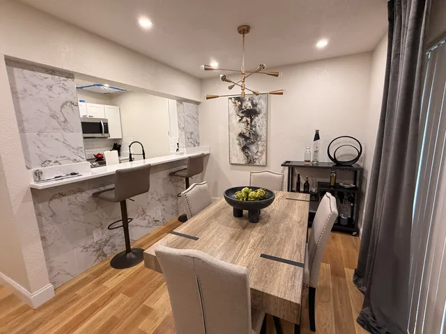 a view of dining room and kitchen with a table chairs and projector