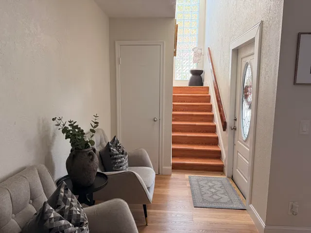 a living room with furniture and a stairs