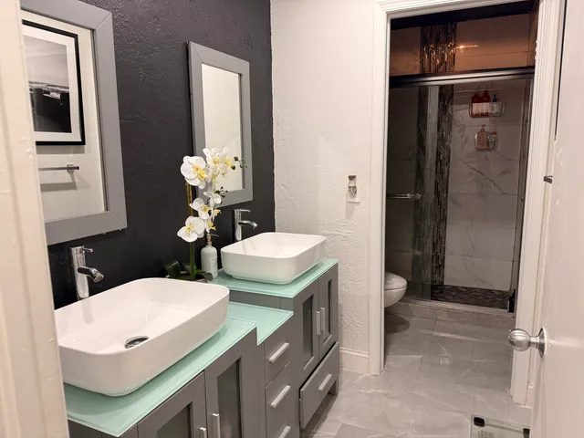 a bathroom with a toilet sink and mirror