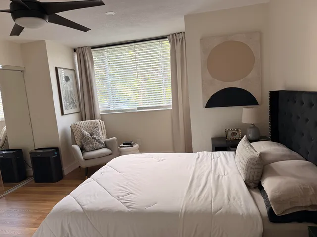 a bedroom with a bed and wooden floor