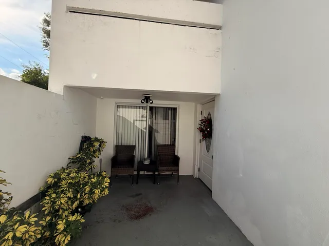 a room with air conditioner duct and white walls