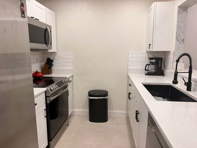 a kitchen with a sink stove and microwave