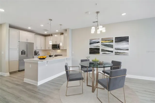 a kitchen with stainless steel appliances kitchen island granite countertop a refrigerator and microwave