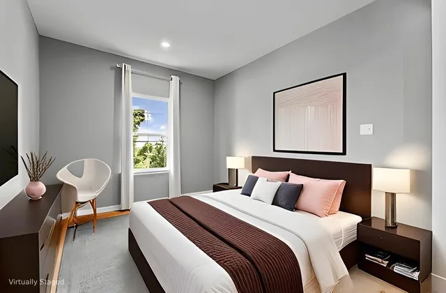 a bedroom with a bed and a painting on the wall