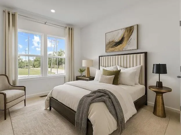 a large kitchen with kitchen island a sink a stove a refrigerator and white cabinets with wooden floor