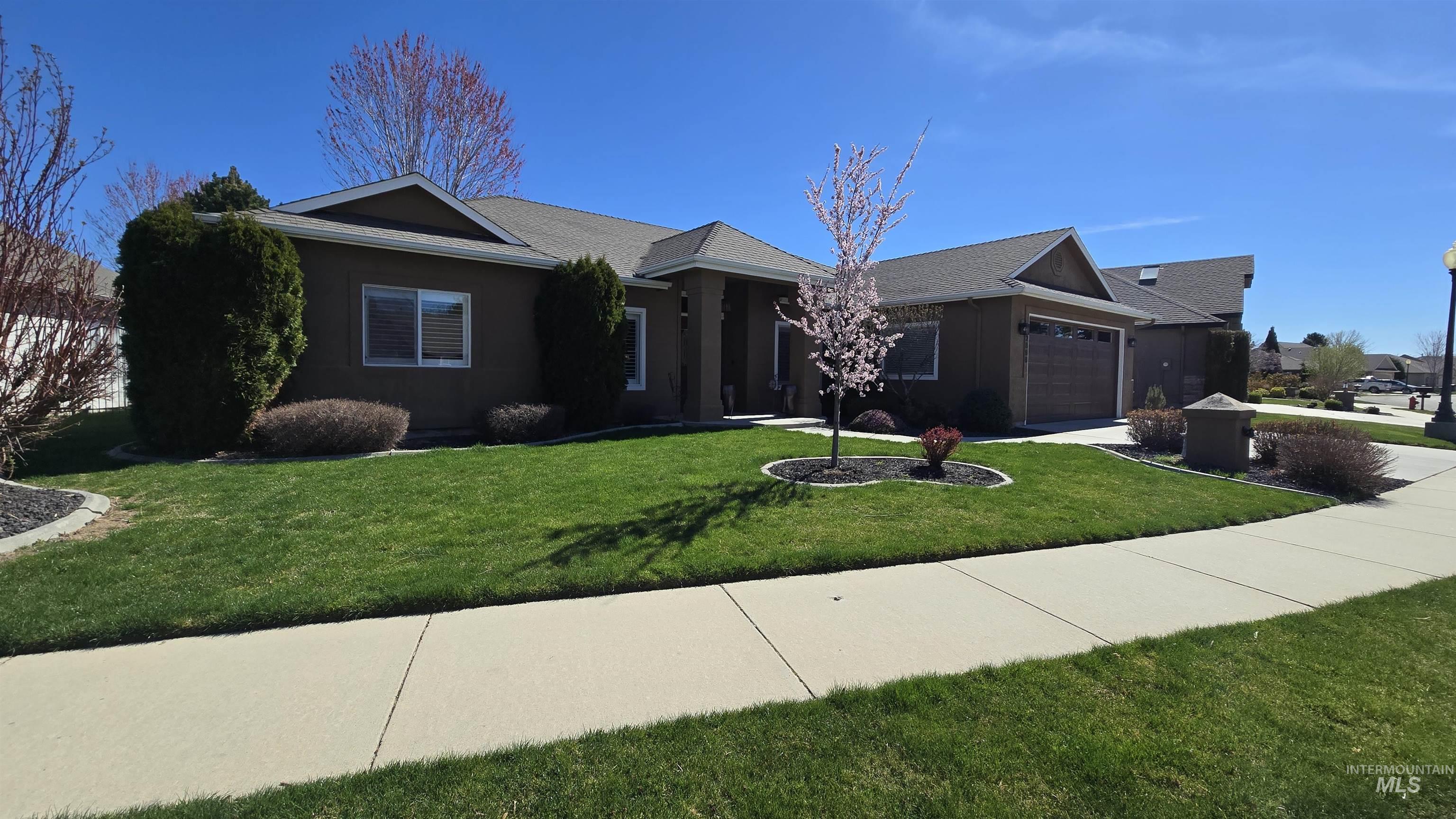 2898 North Silverleaf Way Meridian, ID 83646 - Photo 1 of 26 Single story home featuring a garage, a front lawn, stucco siding, and concrete driveway