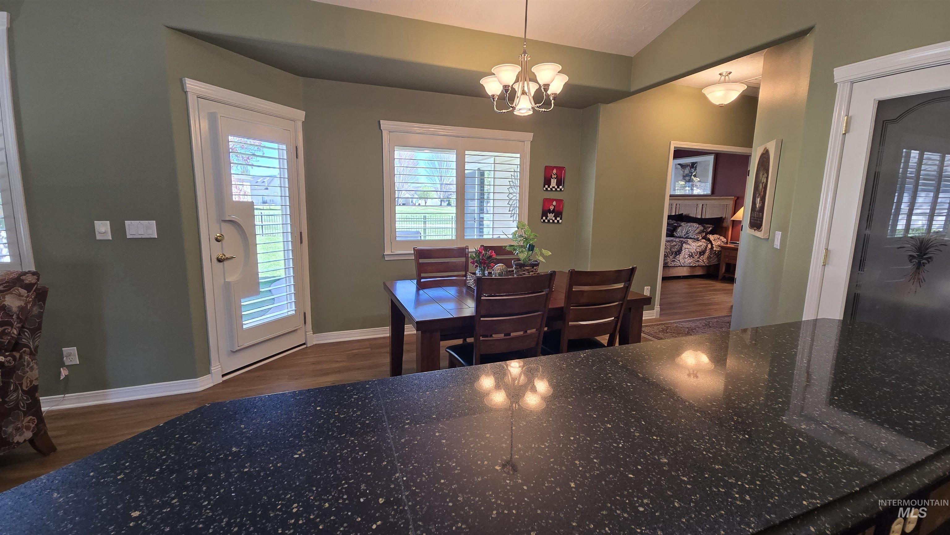 2898 North Silverleaf Way Meridian, ID 83646 - Photo 15 of 26 Dining space with dark wood-type flooring, lofted ceiling, and a chandelier