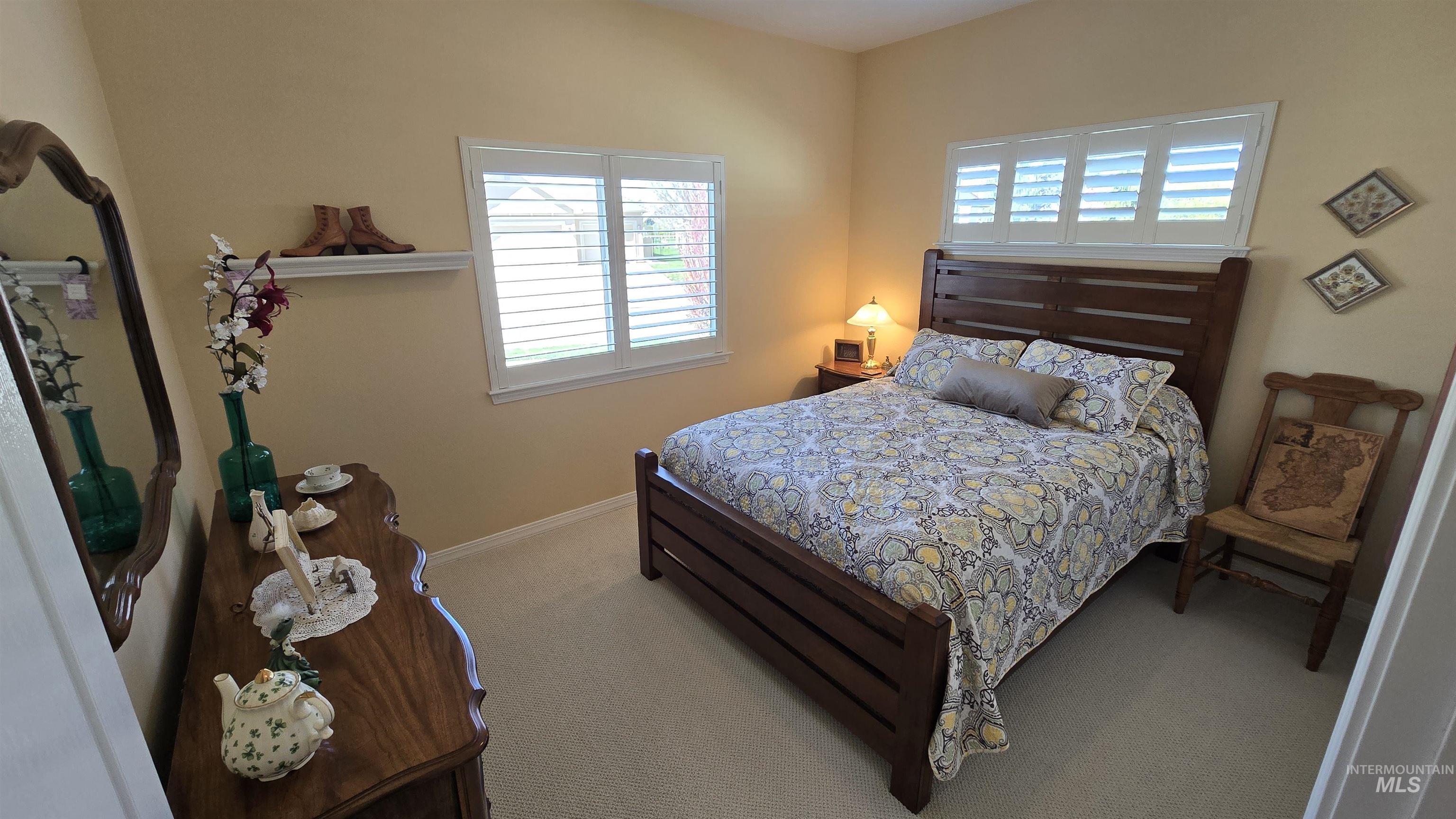 2898 North Silverleaf Way Meridian, ID 83646 - Photo 19 of 26 Bedroom with light carpet and baseboards