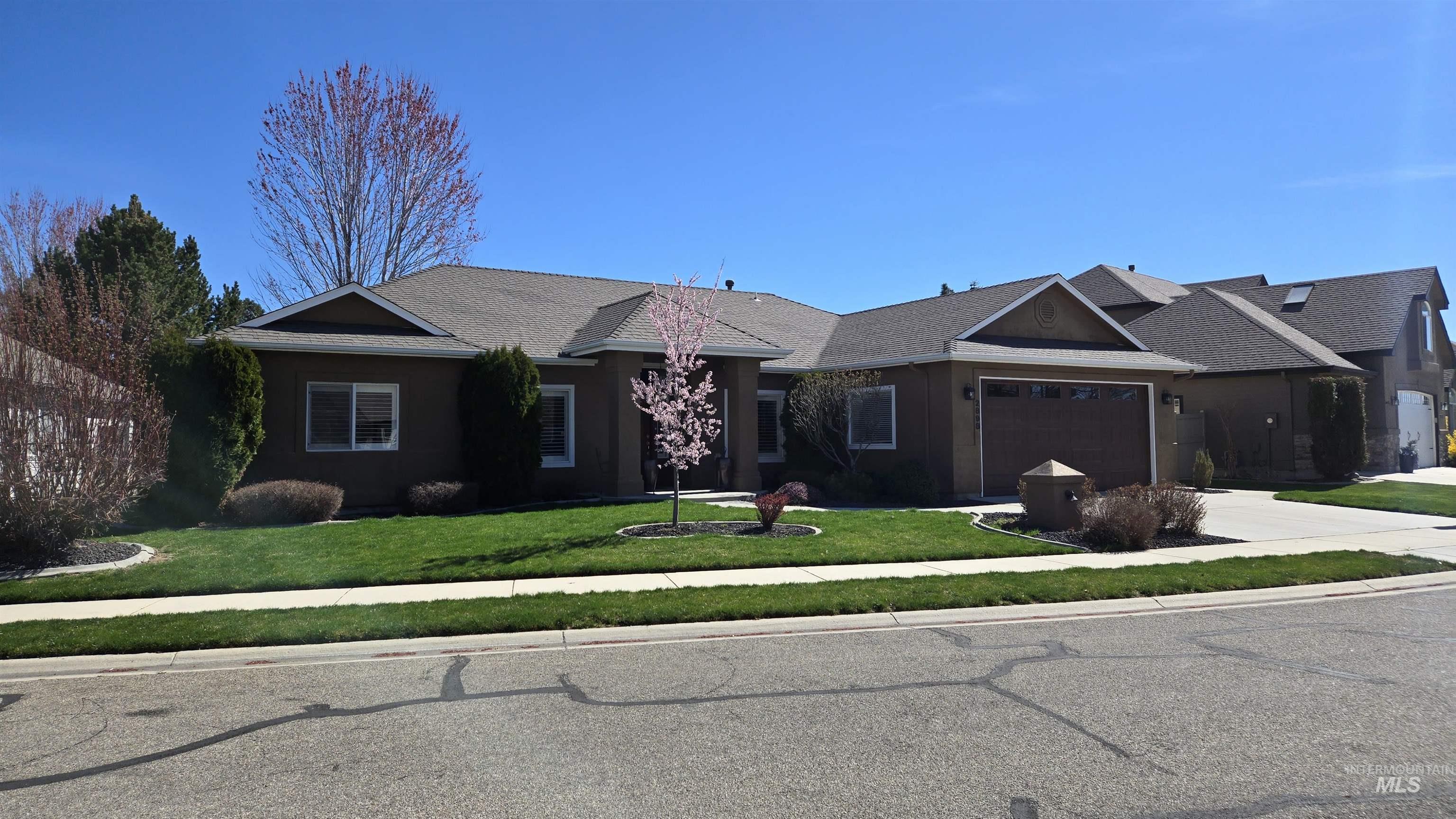 2898 North Silverleaf Way Meridian, ID 83646 - Photo 2 of 26 Ranch-style home featuring a front yard, driveway, a garage, and stucco siding