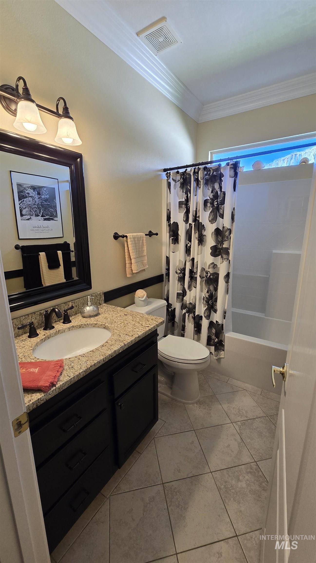 2898 North Silverleaf Way Meridian, ID 83646 - Photo 21 of 26 Bathroom featuring vanity, crown molding, shower / tub combo with curtain, and light tile patterned flooring