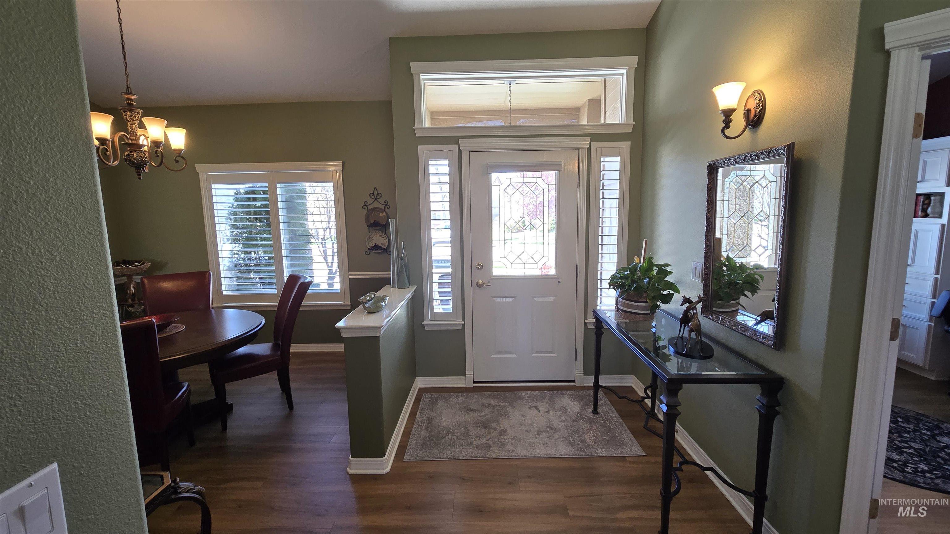 2898 North Silverleaf Way Meridian, ID 83646 - Photo 25 of 26 Foyer with dark wood-style floors and hanging lights