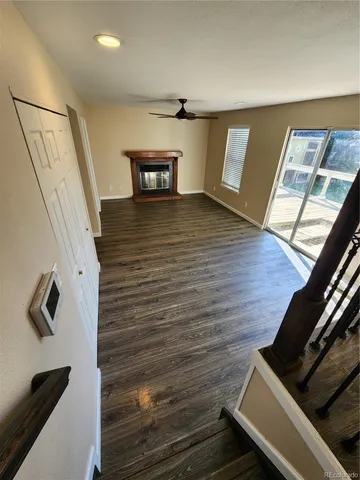 a view of an empty room and wooden floor