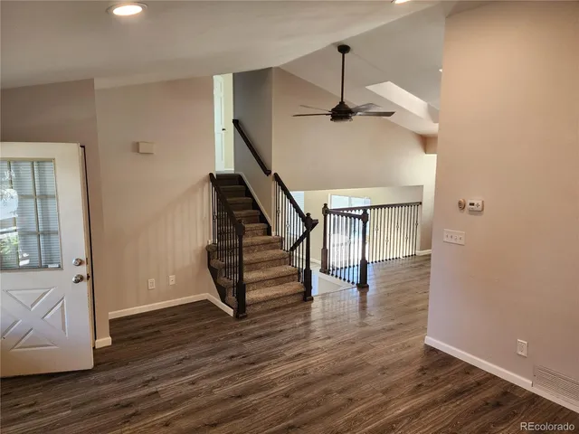 a view of entryway and hall with wooden floor