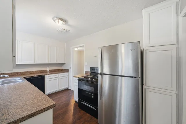 a kitchen with a refrigerator and a sink
