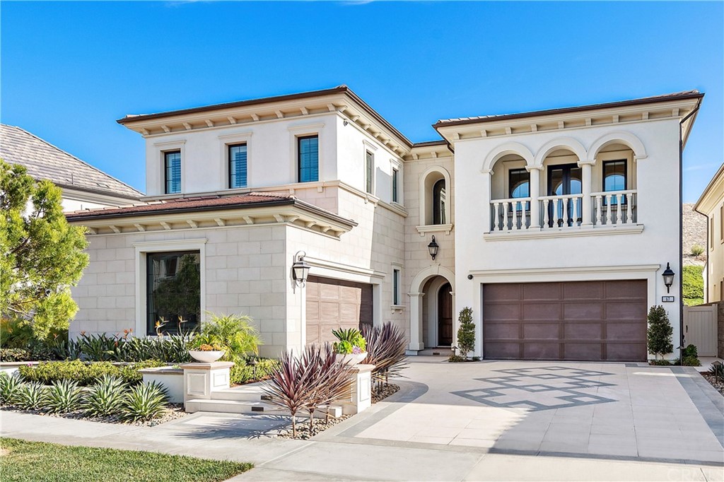 a view of a white house with a yard and plants